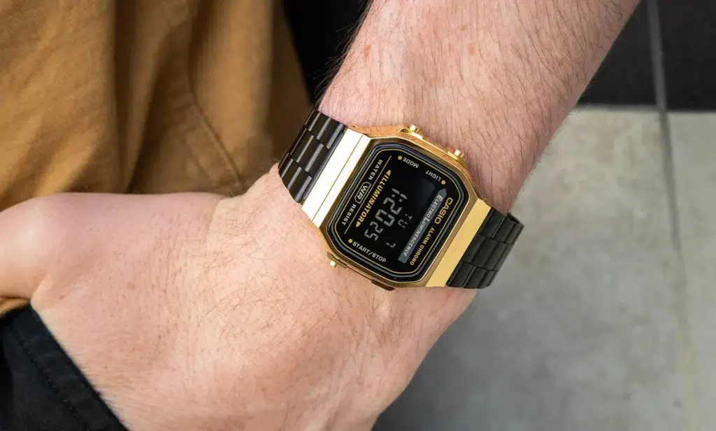 ''Casio'' pulkstenis uz vīrieša rokas, kas atrodas kabatā.