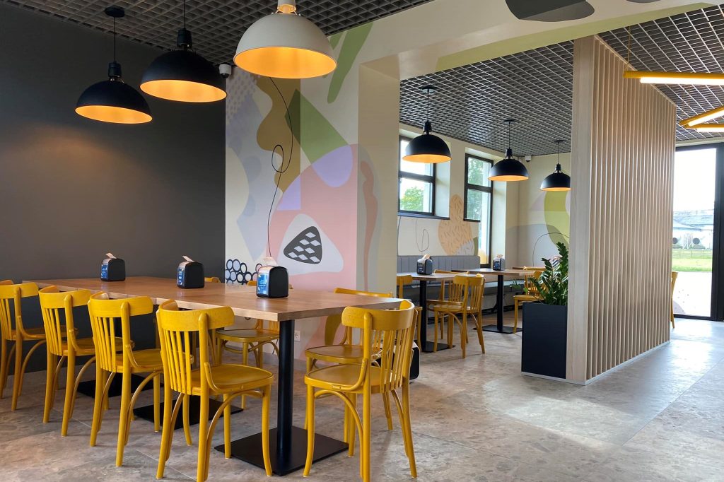 Pusdienu kafējnīca O!Bistro ar gaiši un krāsainu interjeru.